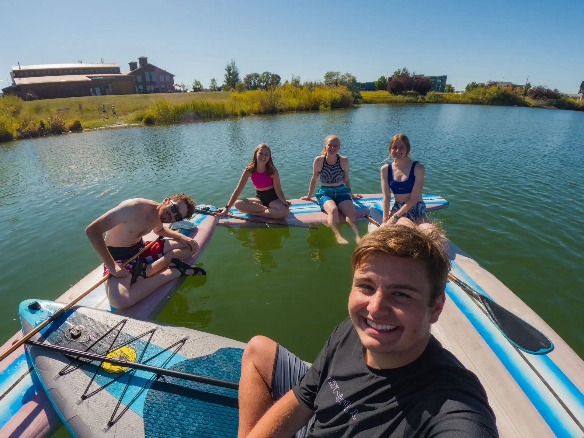 the couple on paddle boards at the beach